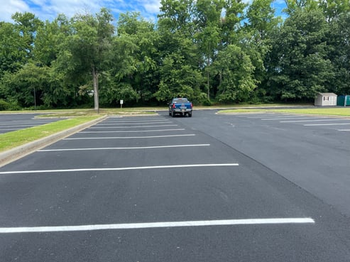 Commercial parking lot in good condition with minor oxidation and a smooth surface, perfect candidate for sealcoating."