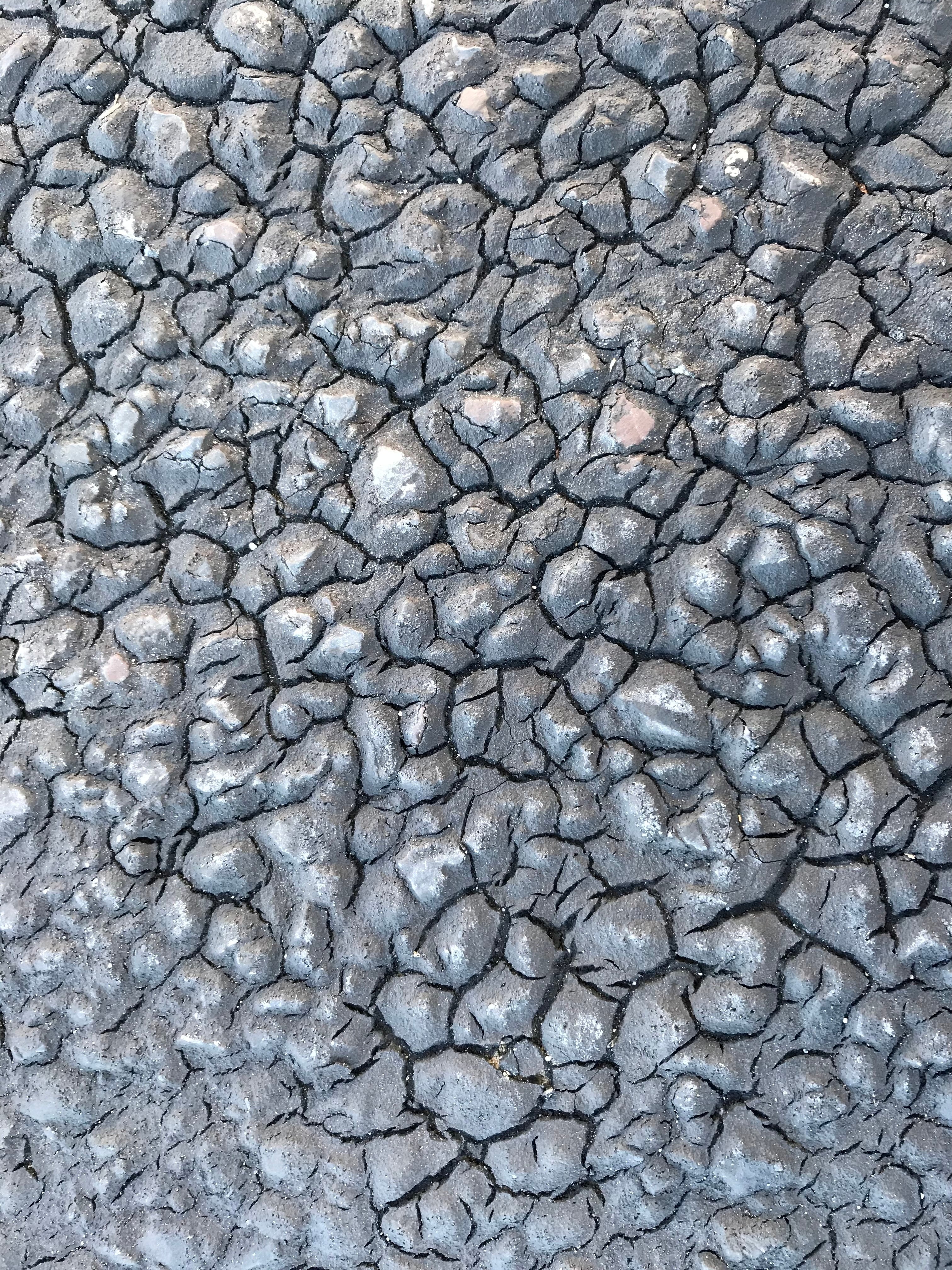 Close-up of brittle, cracked sealcoat that never cured properly because it was applied in cold weather