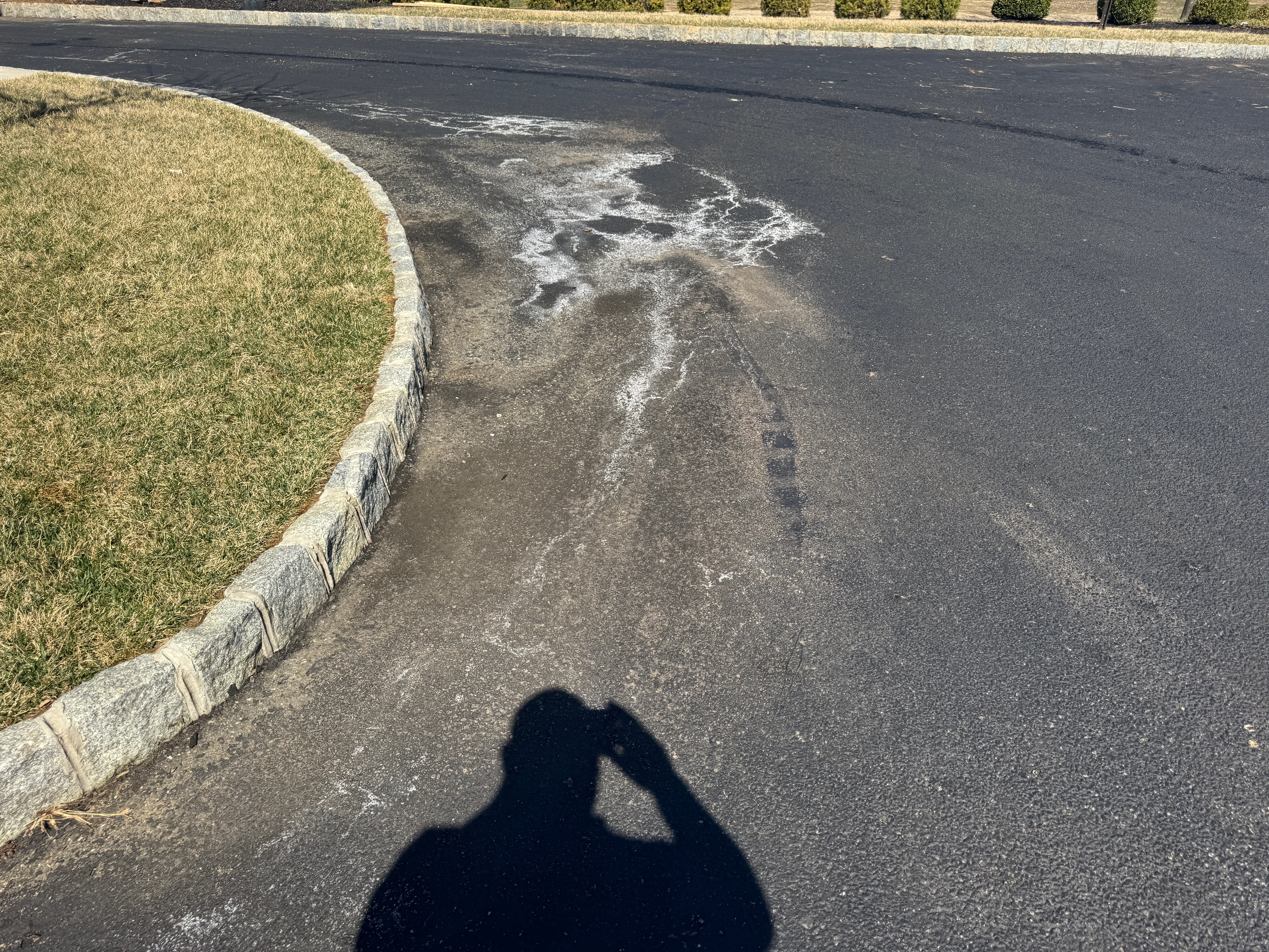 Sealcoating failure in handicap parking spaces due to underground water migration through asphalt