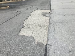 paving_over_cracked_asphalt