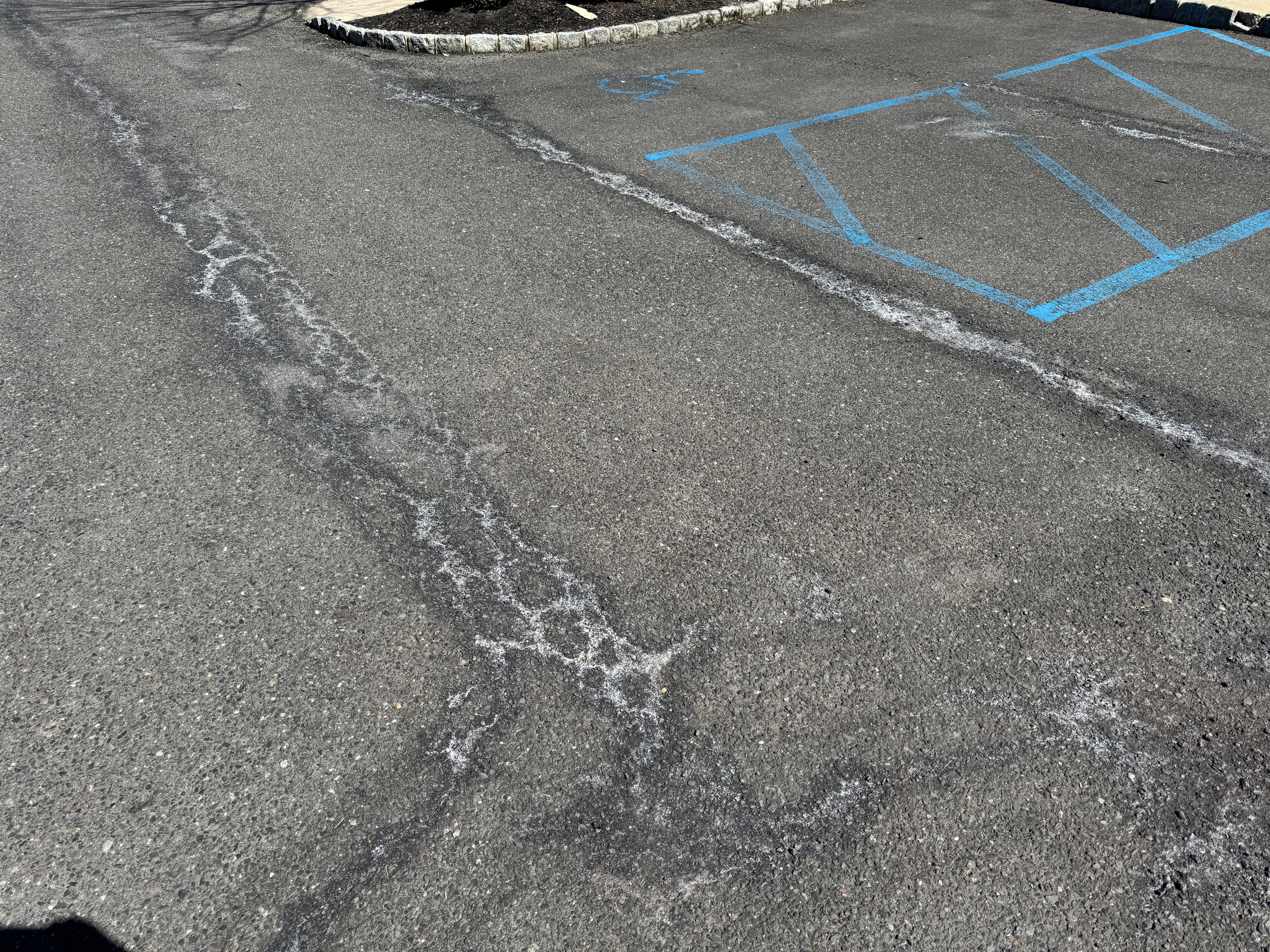 white stains in asphalt parking lots